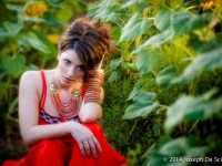 Portrait of a woman amongst sunflowers.