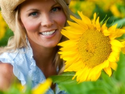 Pretty blond woman with Sunflowers